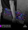 A person is holding a gaming keyboard with RGB lighting. Produktbild-Vorschau