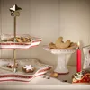 A tiered serving stand with Christmas cookies and a candle. Produktbild-Vorschau