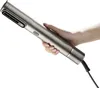 A hand holding a silver hair dryer. Anteprima dell’immagine prodotto