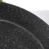 A close-up view of the speckled surface of a black frying pan. Náhled obrázku produktu