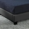 A close-up view of a bed frame and mattress. Náhled obrázku produktu