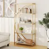 A gold and white bookshelf filled with books and decorative items, placed in a living room setting next to a sofa and a plant. Produktbild-Vorschau