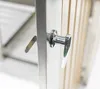Close-up of a metal handle on a wooden structure, possibly a trash bin enclosure. Náhled obrázku produktu