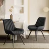 Two black dining chairs are placed around a dining table in a well-lit room. Voir les images du produit