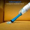 A handheld vacuum cleaner is shown cleaning dirt from a yellow fabric surface. Produktbild-Vorschau