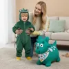 A woman is holding a child dressed in a dinosaur costume next to a green inflatable dinosaur toy. Podgląd zdjęcia produktu