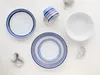A flat lay of a 10-piece dinnerware set with a blue and red striped pattern, along with two decorative items. Náhľad obrázku produktu