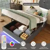 A bed with its storage compartment open, showing organized items and illuminated LED lights. Produktbild-Vorschau