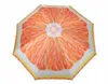 An open umbrella with a grapefruit slice pattern. Produktbild-Vorschau