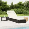 A black rattan sun lounger with a white canopy and cushion is placed on a patio next to a swimming pool, with lush green trees in the background. Náhled obrázku produktu