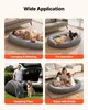 A collage of four images showing a dog bed in various applications: with a person and dog lounging, with multiple dogs interacting, being packed for a camping trip, and with a family. Voir les images du produit