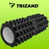 A black textured foam roller with a white end cap is shown against a bright green background. The brand logo 'TRIZAND' is visible at the top. Náhled obrázku produktu