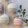 Crocheted Christmas ornaments hanging near a sprig of mistletoe. Produktbild-Vorschau