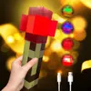 A hand holding a Minecraft-style torch light with several colored lights in the background, and USB charging cables in the foreground. Náhled obrázku produktu