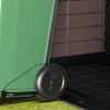 A close-up view of the wheel and lower side of a green storage box, with the interior visible in the background. Náhled obrázku produktu