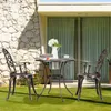 A bistro set with two chairs and a table on a grassy lawn in front of a house. Náhľad obrázku produktu