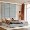 A bedroom scene featuring a bed with a large upholstered headboard. Anteprima dell’immagine prodotto