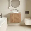 A modern bathroom with a wooden vanity, sink, mirror, and toilet. Anteprima dell’immagine prodotto