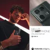 A man holding a smartphone with a close-up of the phone's camera on the right side of the image. Produktbild-Vorschau