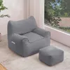 A gray beanbag chair with an ottoman in a living room setting, next to a large window with trees visible outside. Náhľad obrázku produktu