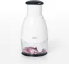 A white manual food chopper with a clear container filled with chopped red onions sits on a white background. Produktbild-Vorschau