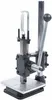 A close-up studio shot of a manual stamping machine. Voir les images du produit
