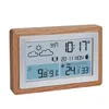 A digital weather station with a wooden frame, displaying time, date, temperature, and weather icons. Podgląd zdjęcia produktu