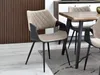A dining chair is shown in a dining room setting. Podgląd zdjęcia produktu