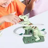 Children playing with a dinosaur toy on a table. Náhled obrázku produktu