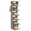 A tall, narrow gray shoe rack with multiple shelves holds various pairs of shoes. There are also two hooks on the side of the rack. Produktbild-Vorschau