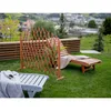 A wooden garden screen and lounge chair are set up on a grassy lawn with a scenic view of a town in the background. Podgląd zdjęcia produktu