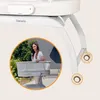 A woman is interacting with a baby bassinet outdoors. Anteprima dell’immagine prodotto