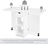 A white folding table with storage shelves and a drawer, with weight limit indicators. Produktbild-Vorschau