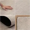 A collage of four images showing different views of a rug, including a hand touching it, a close-up of the texture, and a rolled-up corner. Produktbild-Vorschau