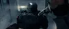 A soldier in dark armor holding a knife in a dimly lit corridor. Produktbild-Vorschau