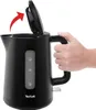 A black Tefal electric kettle with a hand opening the lid. Produktbild-Vorschau