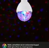 A close-up of a rotating disco ball light bulb projecting colorful lights onto a dark background. Produktbild-Vorschau