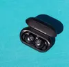 A pair of black wireless earbuds in their open charging case, resting on a textured turquoise surface. Produktbild-Vorschau