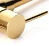 A close-up shot of a gold-colored kitchen faucet handle and part of the spout. Produktbild-Vorschau