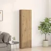 A tall, narrow wooden cabinet stands against a plain wall, next to a sofa and a potted plant. Produktbild-Vorschau