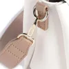 A close-up shot of a handbag strap and hardware. Náhľad obrázku produktu