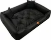 A black dog bed with tufted cushions and two small pillows. Náhľad obrázku produktu