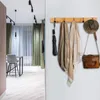 A hallway with a coat rack on the right and a dining area on the left. Produktbild-Vorschau