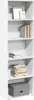 A white bookshelf with several shelves, containing books, framed pictures, and a storage box. Voir les images du produit