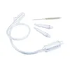 A set of nasal aspirator components, including a tube, tips, and a cleaning brush, laid out on a white background. Voir les images du produit
