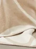 A close-up view of a folded blanket with stripes. Anteprima dell’immagine prodotto