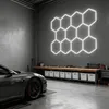 A modern garage or workshop setting with a car and a workbench. Voir les images du produit