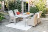An outdoor patio set with a table and chairs on a brick patio. Produktbild-Vorschau