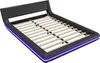 A black bed frame with a slatted mattress support and purple LED lighting around the base. Produktbild-Vorschau
