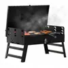 A black portable grill with food cooking on it, with smoke rising. Voir les images du produit